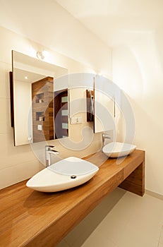 Porcelain sinks on wooden counter