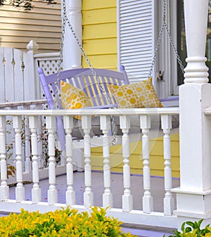 Porch Decor With Lavender Swing and Yellow Pillows photo