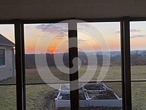 Through porch-garden view -first glimpse of sunrise at dawn