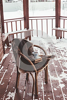 Porch of log cabine with snow