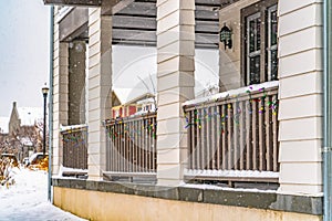 Porch railing with colorful lights seen in winter