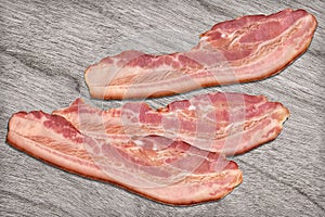 Pork Bacon Rashers Set On Bleached Gray Wood Background
