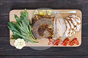 Pork baked ham, cutting slices with herbs, pepper kapi on the cutting board