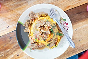 Pork Basil with Egg on table with soft light