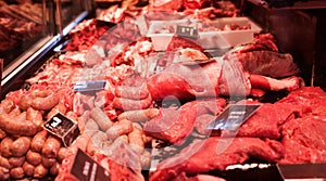 Pork, beef, tenderloin, meatballs, entrecote, ham, carbonate in refrigerator on market counter