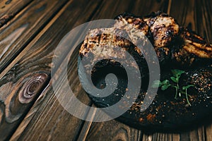 Pork bone steak on a wooden background with honey. Board slate. kenza, pepper