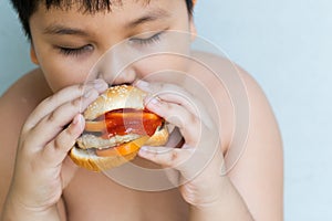 Pork cheese Hamburger in obese fat boy hand