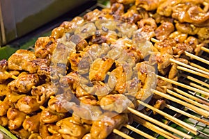 Pork chitterlings grill on banana leaf in walking street photo