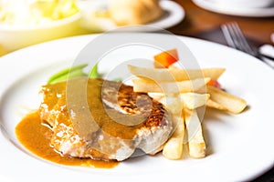 Pork chop with dilicious sauce and french fries