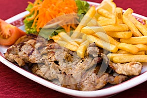 Pork Chop with french fries and salad of carrot an