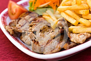Pork Chop with french fries and salad of carrot an