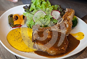 Pork chop steak with sauce and side dish