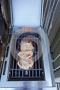 Pork chops Barbecuing On The Grill