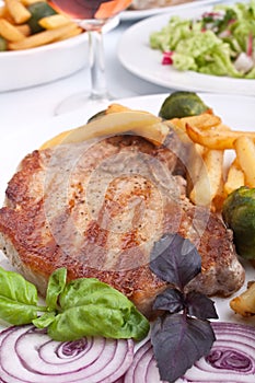 Pork chops with fries and brussels sprouts