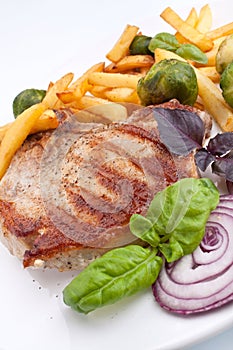 Pork chops with fries and brussels sprouts