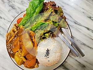 Pork curry with strea rice and fresh vegetable