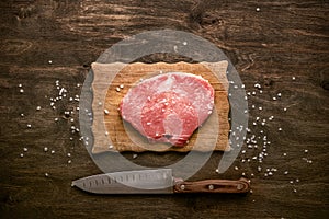 Pork cutlet. A piece of raw meat ready for preparation with spic