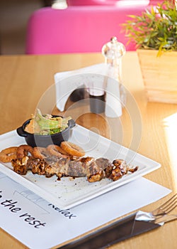 Pork kebabs, bbq meat on plate with Crunchy Deep fried squid ring in batter with a delicious sauce. Beautiful stylish menu.