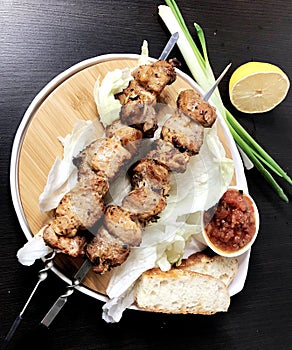 Pork kebabs, bbq meat on plate, top view.