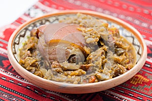 Pork knuckle with stew cabbage on a plate