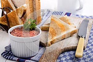 Pork liver sausage and slice bread on wooden board