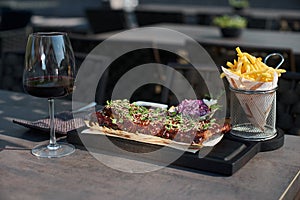 Pork loin ribs served on chopping board, potato