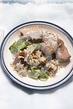 Pork loin with rice, spinach and sun dried tomatoes