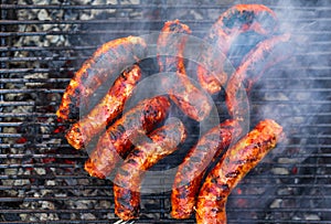 Pork meat and sausages grilled on a charcoal barbeque. Top view of tasty barbecue, food concept, food on grill and detail of food