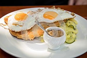 Pork meat Schnitzel Hamburg style with fried eggs, potato cucumber salad and Bavarian sweet mustard in Biergarten restaurant photo