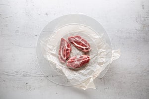 Pork meat. Pork slieces on white conkrete background