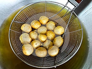 Pork meatballs being fried
