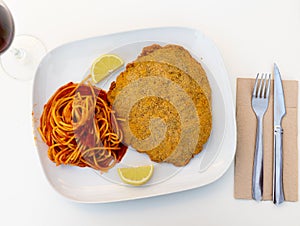 Pork Milanese with spaghetti in tomato sauce