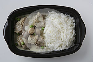 Pork, mushrooms with basmati rice in plastic dish