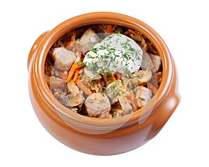 Pork with mushrooms, carrots and onions in a ceramic crock pot, photo