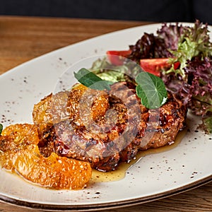 Pork neck with orange mustard and fennel. Pork Neck steak of grilled Pork shop steak in white plate.