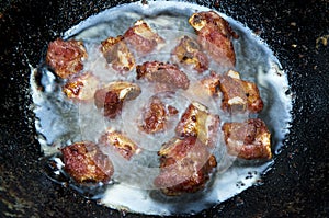 Pork in oil pan.