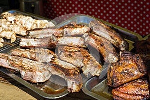 Pork ribs cooked on the grill lie on a tray