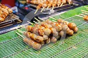 Pork and rice sausage or fermented hot dog northeastern isan thai style hanging in hawker stall for sale