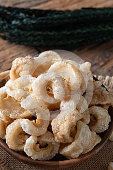 Pork rinds also known as chicharon or chicharrones , kab moo