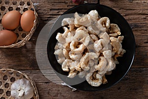 Pork rinds also known as chicharon or chicharrones , kab moo