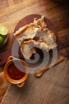 Pork rinds and red hot sauce mexican food flatlay