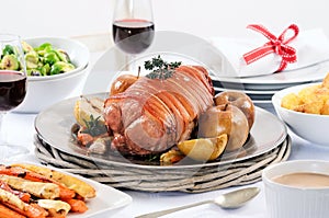 Pork roast dinner with vegetable, potato sides and wine photo