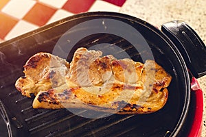 Roasted pork on a hot stove with smoke.