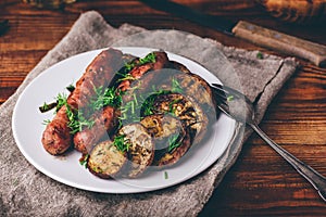 Pork Sausages Baked with Eggplant and Herbs