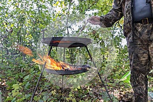 Pork sausages cooked fast on a campfire in nature