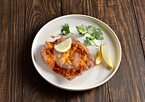 Pork schnitzel with lemon and leaves of parsley