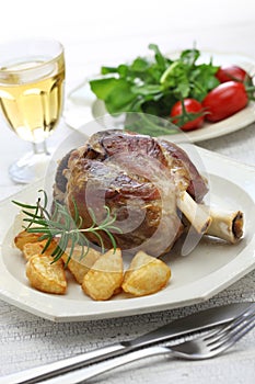 Pork shank with roasted potatoes, italian cuisine