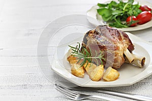 Pork shank with roasted potatoes, italian cuisine photo