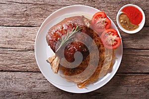 Pork shank, sauerkraut and sauce. horizontal top view