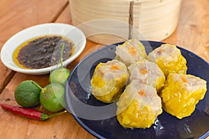 Pork and shrimp siomai dumplings served with chili garlic oil and calamansi